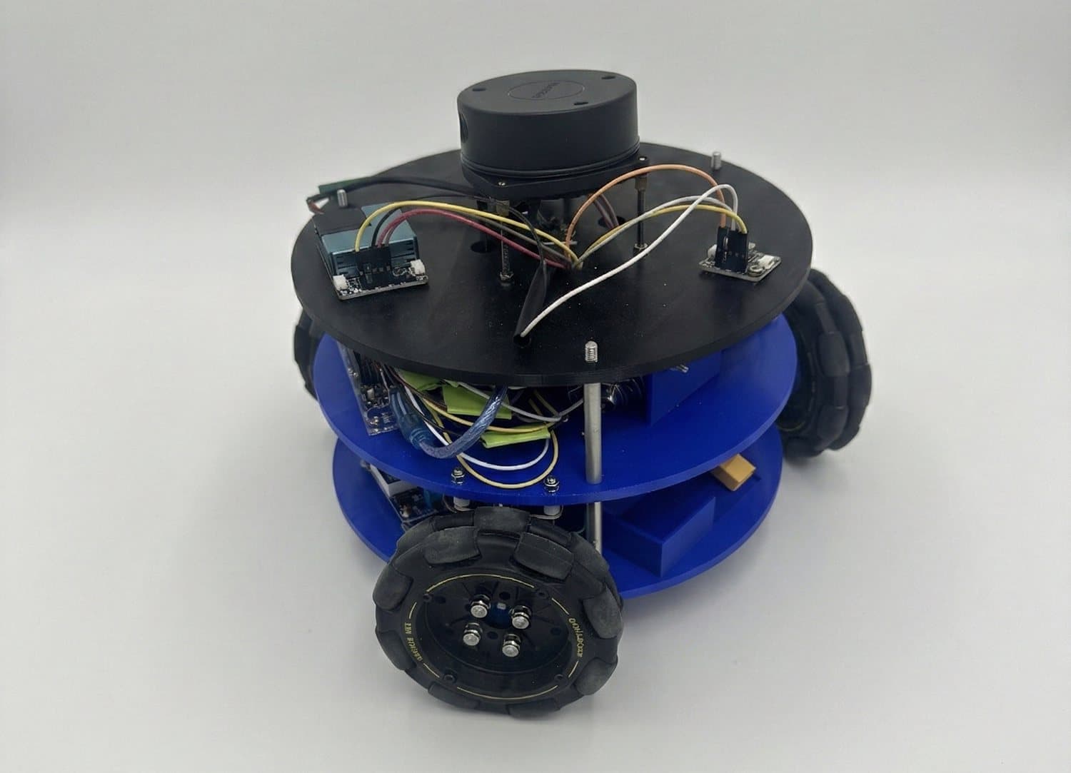 Custom two-deck mobile robot with a top-mounted LiDAR, air-quality sensor boards, and omnidirectional wheels